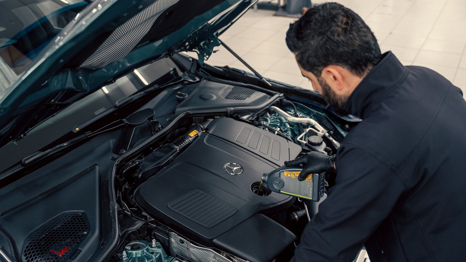 Mechanic checking engine oil level